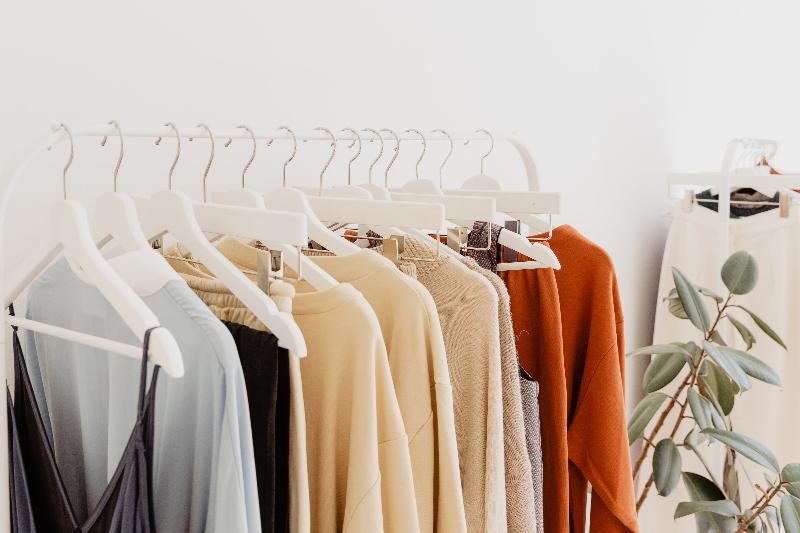 Minimalist clothing display in retail store, stylish and clean setup for modern fashion presentation